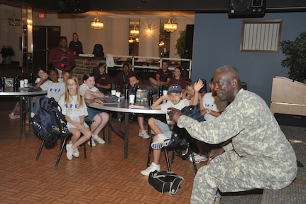 OFFUTT AIR FORCE BASE, Neb - Major General Abraham J. Turner, Chief of Staff, United States Strategic Command, talks with children at the Offutt Community Center who are participating in the Drug Education For Youth program.  More than 25 children ages 9-12 are participating in the eight day phase one event of the two phase program.  Phase two DEFY events will include monthly activities and mentoring throughout the school year.  The DEFY program at Offutt is staffed by volunteers from the United States Strategic Command, Strategic Communications Wing One Detachment Offutt (Navy), Defense Intelligence Agency and the 55th Force Support Squadron (Air Force).  DEFY originated in 1993 as a drug demand reduction program geared towards substance abuse awareness and life skills for Navy and Marine Corps dependent youths aged 9-12.  The program has expanded to 56 Navy and Marine Corps sites world-wide, and is partnered with the Department of Air Force which also has sites world-wide  and the Department of Justice, which has sites in the United States.