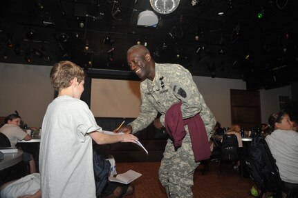 OFFUTT AIR FORCE BASE, Neb - Major General Abraham J. Turner, Chief of Staff, United States Strategic Command, talks with children at the Offutt Community Center who are participating in the Drug Education For Youth program.  More than 25 children ages 9-12 are participating in the eight day phase one event of the two phase program.  Phase two DEFY events will include monthly activities and mentoring throughout the school year.  The DEFY program at Offutt is staffed by volunteers from the United States Strategic Command, Strategic Communications Wing One Detachment Offutt (Navy), Defense Intelligence Agency and the 55th Force Support Squadron (Air Force).  DEFY originated in 1993 as a drug demand reduction program geared towards substance abuse awareness and life skills for Navy and Marine Corps dependent youths aged 9-12.  The program has expanded to 56 Navy and Marine Corps sites world-wide, and is partnered with the Department of Air Force which also has sites world-wide  and the Department of Justice, which has sites in the United States.