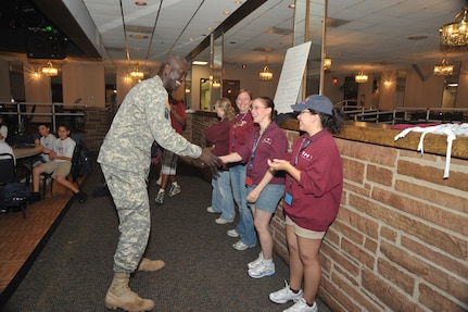 OFFUTT AIR FORCE BASE, Neb - Major General Abraham J. Turner, Chief of Staff, United States Strategic Command, shakes hands with a coordinator for the Drug Education For Youth program at the Offutt Community Center.  More than 25 children ages 9-12 are participating in the eight day phase one event of the two phase program.  Phase two DEFY events will include monthly activities and mentoring throughout the school year.  The DEFY program at Offutt is staffed by volunteers from the United States Strategic Command, Strategic Communications Wing One Detachment Offutt (Navy), Defense Intelligence Agency and the 55th Force Support Squadron (Air Force).  DEFY originated in 1993 as a drug demand reduction program geared towards substance abuse awareness and life skills for Navy and Marine Corps dependent youths aged 9-12.  The program has expanded to 56 Navy and Marine Corps sites world-wide, and is partnered with the Department of Air Force which also has sites world-wide  and the Department of Justice, which has sites in the United States.