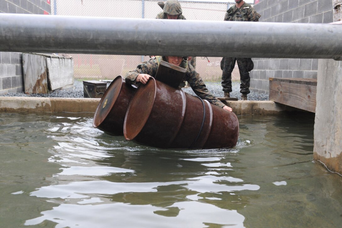 Candidates from Golf Company, Officer Candidate School, conduct the Leadership Reaction Course aboard Marine Corps Base Quantico, Va., June 4, 2009. The LRC is designed to test a candidate's quick thinking and problem solving skills and encourage team work among the candidates. (U.S. Marine Corps photo by LCpl John Kennicutt/Not Released)