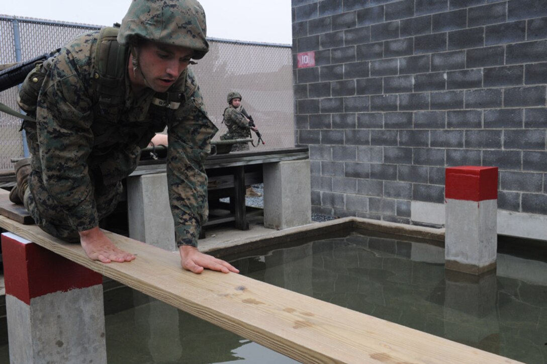 Candidates from Golf Company, Officer Candidate School, conduct the Leadership Reaction Course aboard Marine Corps Base Quantico, Va., June 4, 2009. The LRC is designed to test a candidate's quick thinking and problem solving skills and encourage team work among the candidates. (U.S. Marine Corps photo by LCpl John Kennicutt/Not Released)