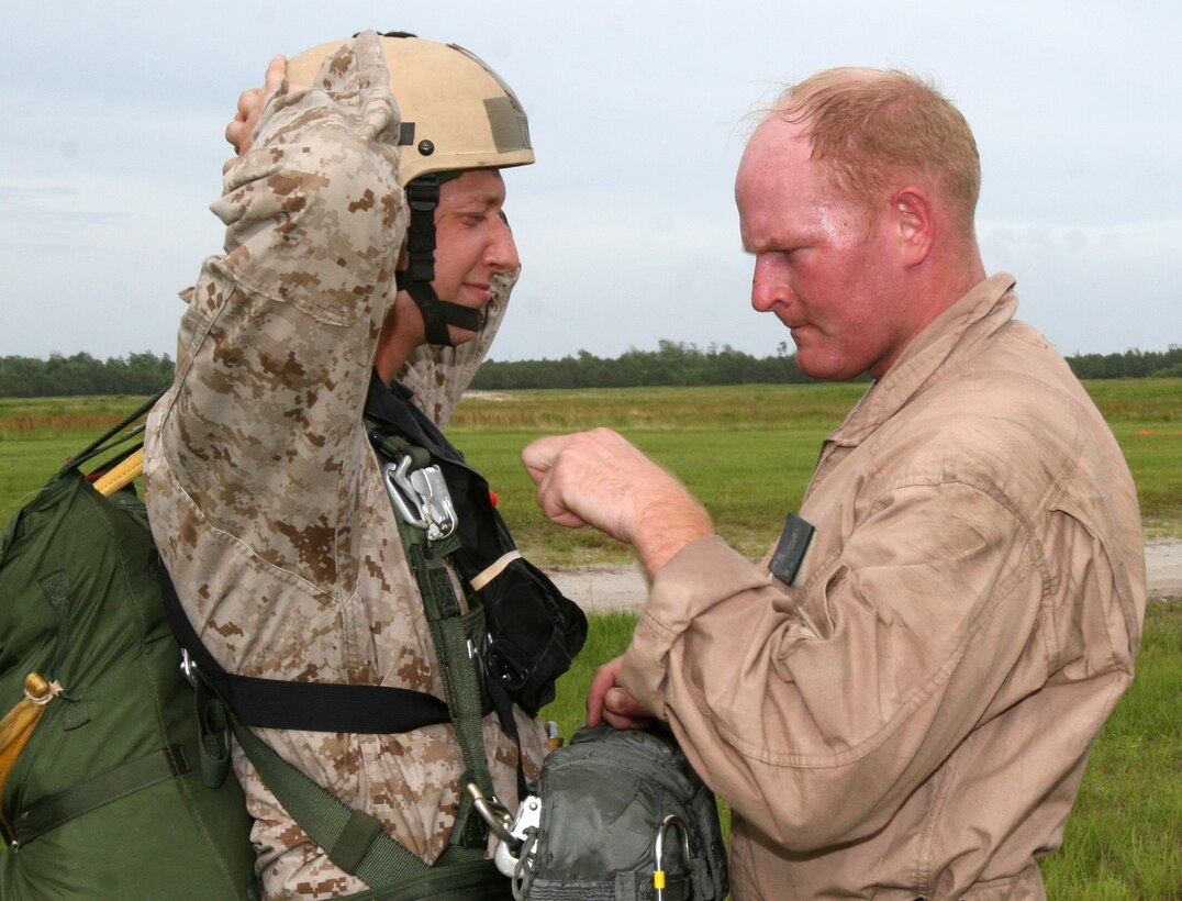 Sergeant Jeremiah Kuepper, jump master team leader with 2nd Reconnaissance Battalion, 2nd Marine Division, performs a safety check on a Marine before jump training, here, June 5. (Official U.S. Marine Corps photo by Lance Cpl. John A. Faria) (RELEASED)