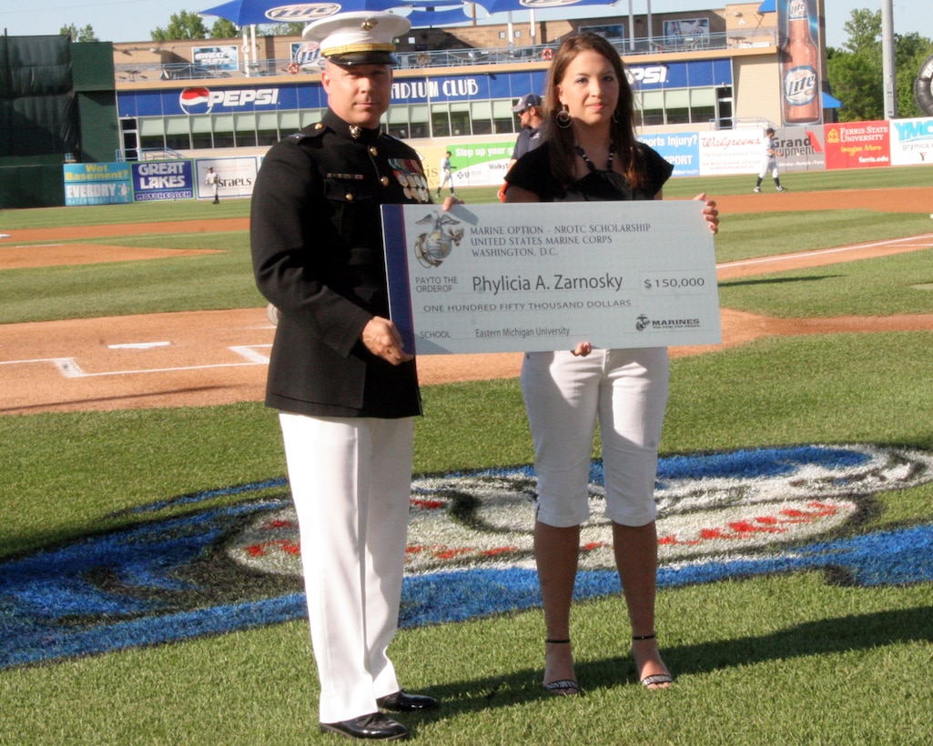 Phylicia Zarnosky, a native of Grand Rapids, MI, and 2008 graduate of Kenowa Hills High School, received a $150,000 scholarship from Capt. Paul Vanderwater, executive officer Recruiting Station Lansing, for her outstanding academics and leadership ability at the White Caps baseball game June 5, 2009. Out of over 230 applicants in the Midwest only 49 were awarded.