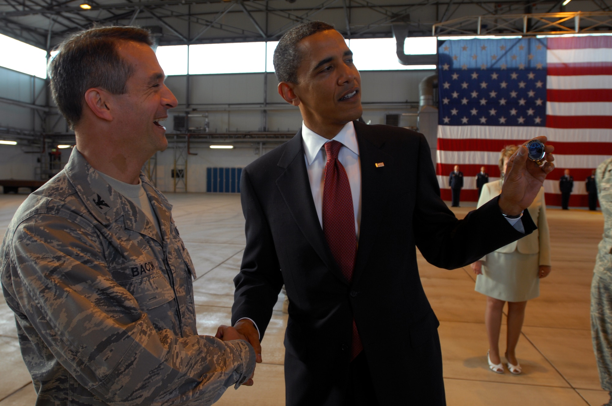 President Barak Obama shows off a 435th Air Base Wing coin given to him by Col. Don Bacon, 435th ABW commander, June 5, 2009, Ramstein Air Base, Germany. President Obama arrived at Ramstein en route to Landstuhl Regional Medical Center, Germany to visit wounded U.S. military members being treated there.(U.S. Air Force photo by Senior Airman Kenny Holston)
