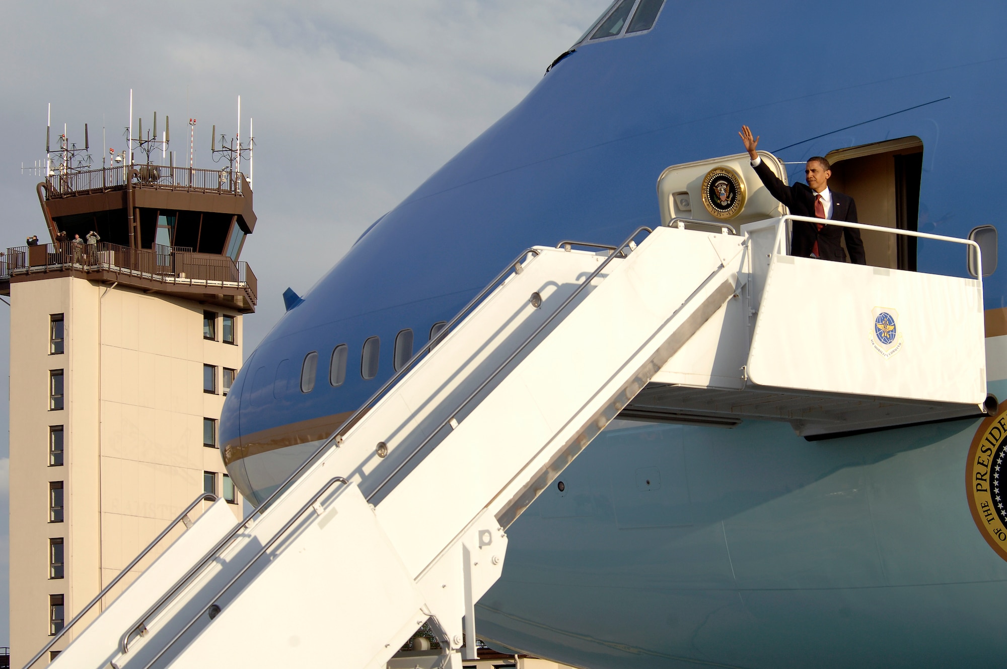 United States President Barack Obama, waves to the crowd as he enters Air Force One at Ramstein Air Base, Germany, June 5, 2009. President Obama arrived at Ramstein en route to Landstuhl Regional Medical Center, Germany, to visit wounded U.S. military members being treated there. (U.S. Air Force photo by Senior Airman Kenny Holston)