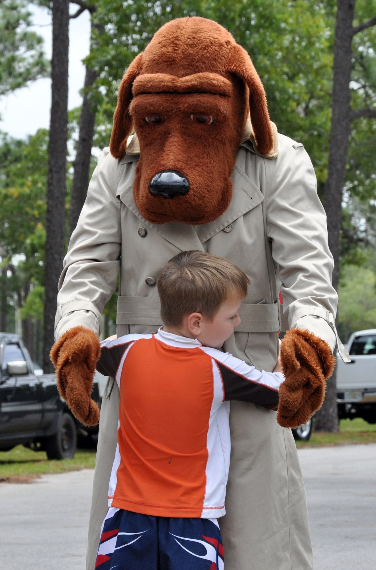 EGLIN AIR FORCE BASE, Fla. – ‘McGruff the Crime Dog’ gives a child a hug during the base community picnic June 5. (U.S. Air Force photo/ Airman Anthony Jennings)