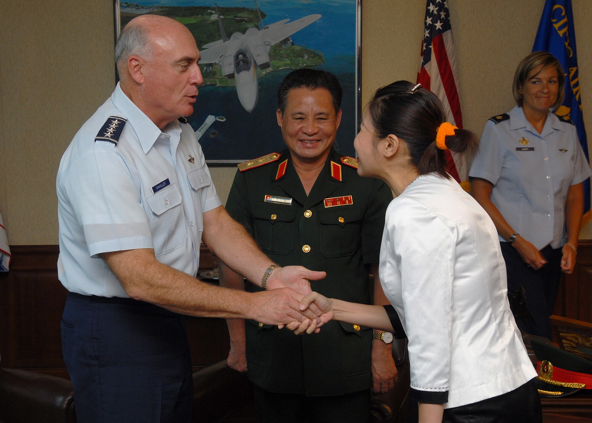 Gen. Howie Chandler, Pacific Air Forces commander, greets Hoa Nguyen, a Vietnamese interpreter and translator for Vietnamese military officials who visited Hickam Air Force Base, Hawaii, June 2. The visitors were part of the Vietnam Search and Rescue Committee and met to discuss several upcoming humanitarian and search and rescue exercises . (U.S. Air Force photo/Tech. Sgt. Jerome Tayborn)