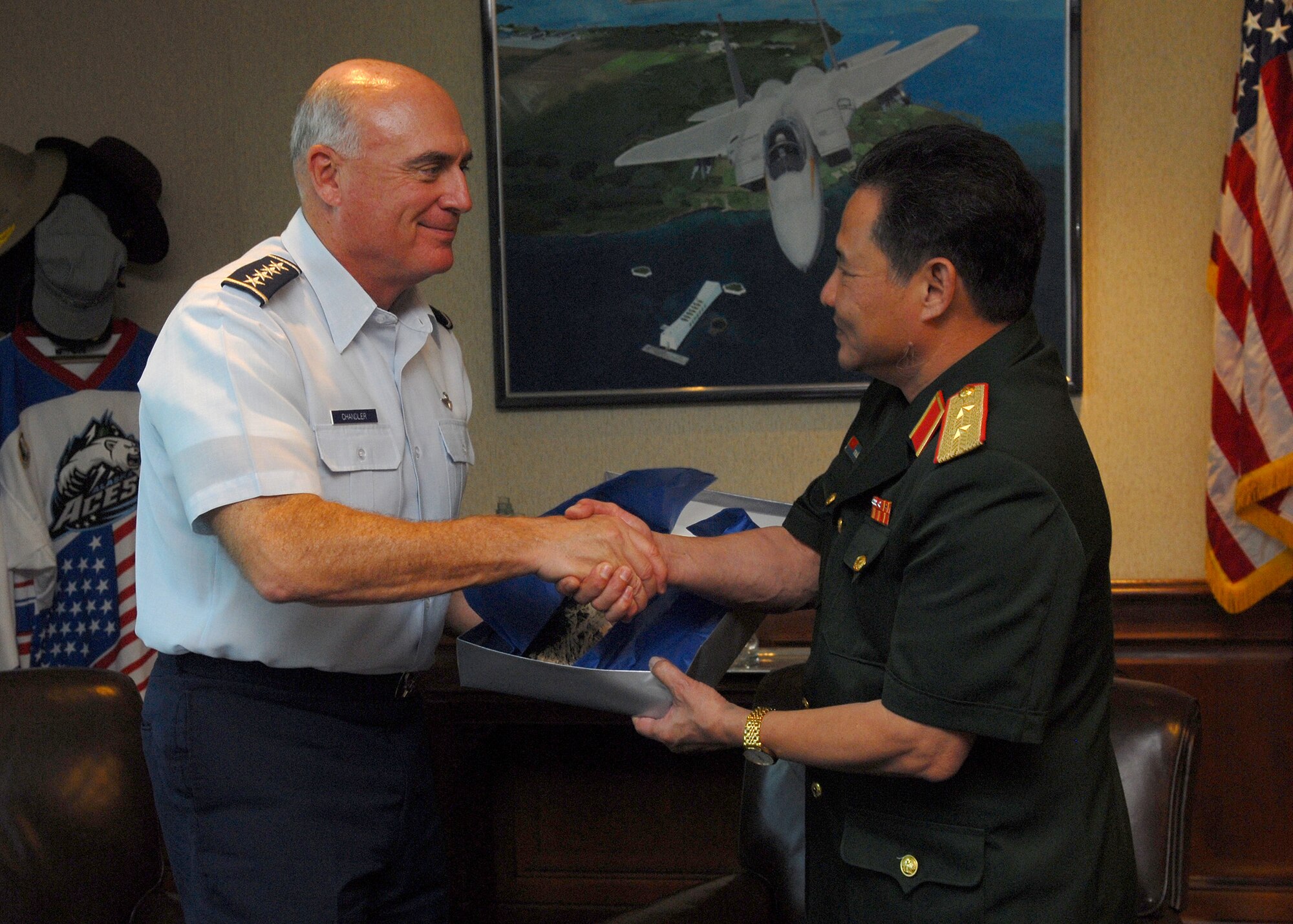 Gen. Howie Chandler, Pacific Air Forces commander, shakes hands with Lt. Gen. Tran, Quag Khue, standing vice chairman of the Vietnam National Search and Rescue Committee, June 2 during an office call at Hickam Air Force, Hawaii. General Khue was joined by six other Vietnamese military officials. (U.S. Air Force photo/Tech. Sgt. Jerome Tayborn)