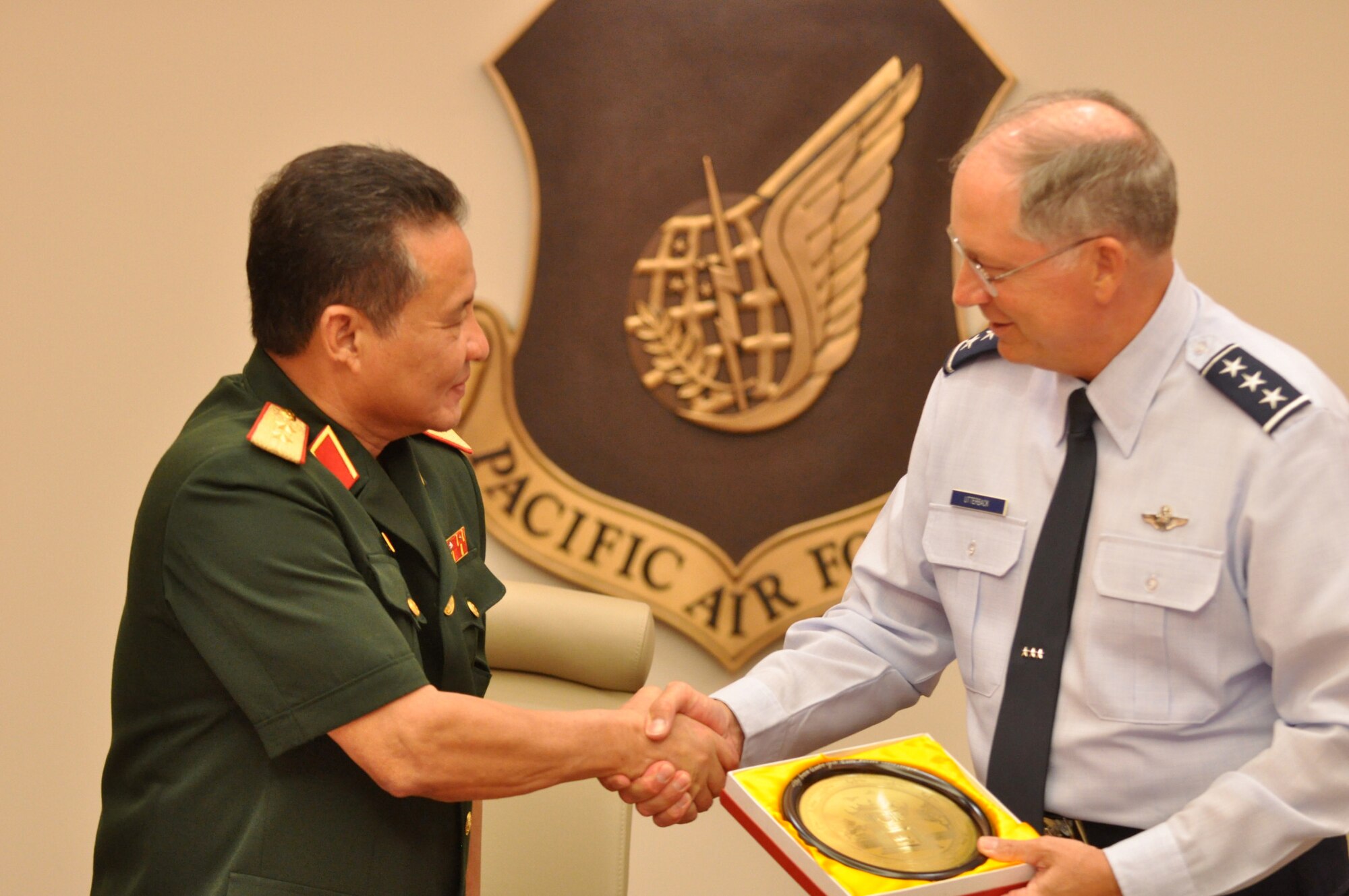 Lt. Gen. Chip Utterback, 13th Air Force commander, shakes hands with Lt. Gen. Tran, Quang Khue, standing vice chairman of the Vietnam National Search and Rescue Committee, June 2 at Hickam Air Force Base, Hawaii. General Khue and six other Vietnamese military officials met with Pacific Air Forces leadership to discuss several upcoming humanitarian and search and rescue exercises taking place in Vietnam. (U.S. Air Force photo/Tech. Sgt. Cohen A. Young)