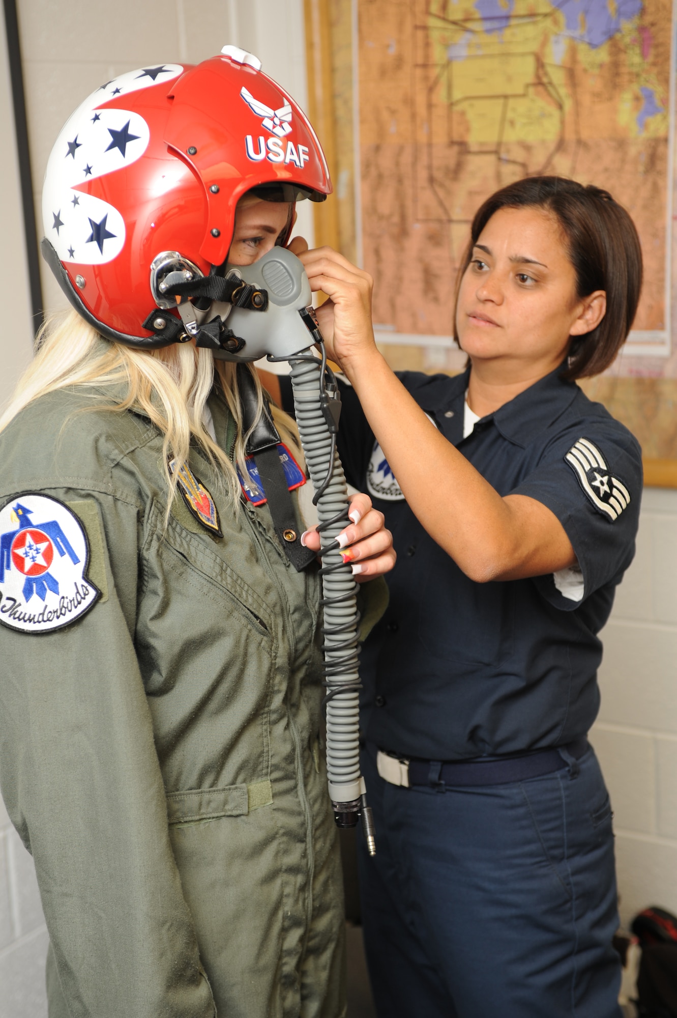 Staff Sgt. Robbin Bailon (right), Thunderbirds flight equipment technician, adjusts a helmet and face mask on Megan Funk during her flight suit fitting June 4 at Hill Air Force Base, Utah. Mrs. Funk was selected as a Hometown Hero for her volunteer service to the community and received a flight in a Thunderbird F-16 Fighting Falcon. (U.S Air Force photo by Tech. Sgt. Russ Martin)