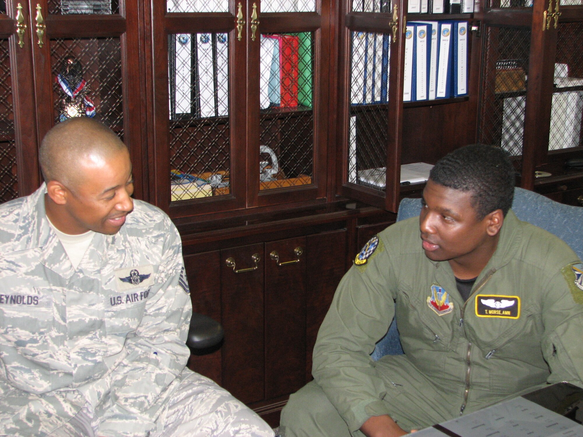 Master Sgt. Dana Reynolds, right, speaks with Airman 1st Class Theodore Morse at the Career Assistance Advisor's office