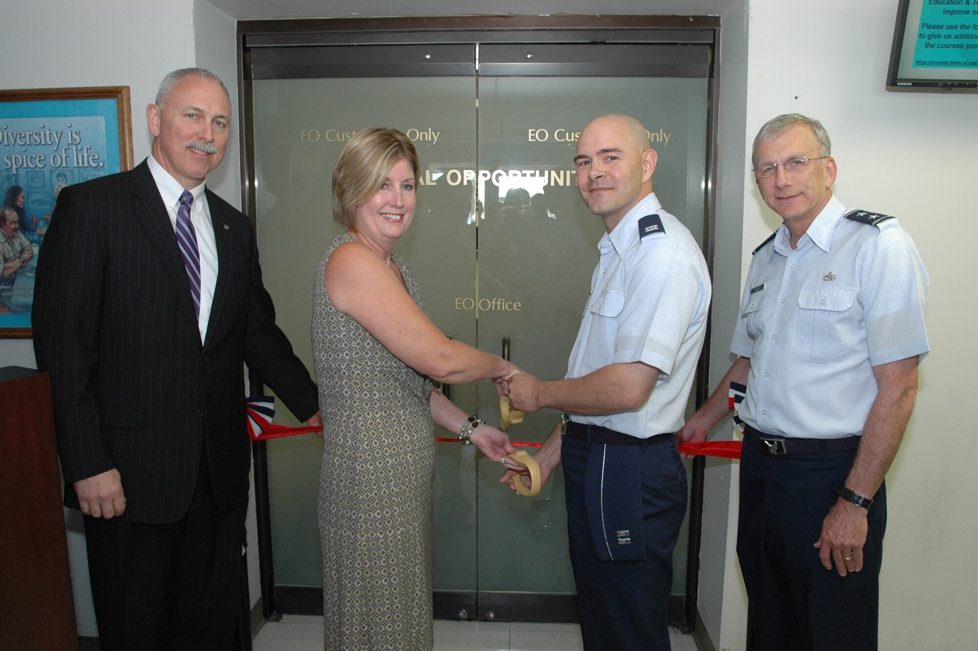 From left, Mr. John Over, Oklahoma City Air Logistics Center executive director; Paula Cochnauer, former Equal Opportunity director; Capt. Ralph Prince, current EO director; and Maj. Gen. David Gillett, OC-ALC commander, cut the ribbon June 1 at the grand opening of the new Equal Opportunity office in Bldg. 201 East.    Recently, the Equal Opportunity Office moved from Bldg. 3001 to Bldg. 201E. Designated customer parking will be located on the east side of Bldg. 201E, Avenue C.  All telephone and fax numbers remained the same. The new mailing address is OC-ALC/EO, 7751 1st St., Bldg 201E, Tinker AFB, OK 73145. (Air Force photo/Margo Wright)
