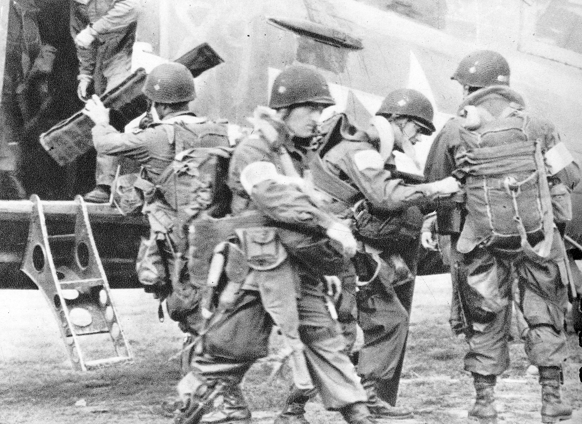 82nd Airborne members check their equipment before boarding a 442nd Troop Carrier Group C-47 bound for Drop Zone "T" near St. Mere Eglise in Normandy on D-Day, June 6, 1944. The 442nd Troop Carrier Group launched 45 C-47s with approximately 20 soldiers in each aircraft. The 442nd TCG was the World War II predecessor of the 442nd Fighter Wing, an Air Force Reserve Command A-10 Thunderbolt II unit based at Whiteman Air Force Base, Mo. (Photo courtesy of the Herky Barbour estate)