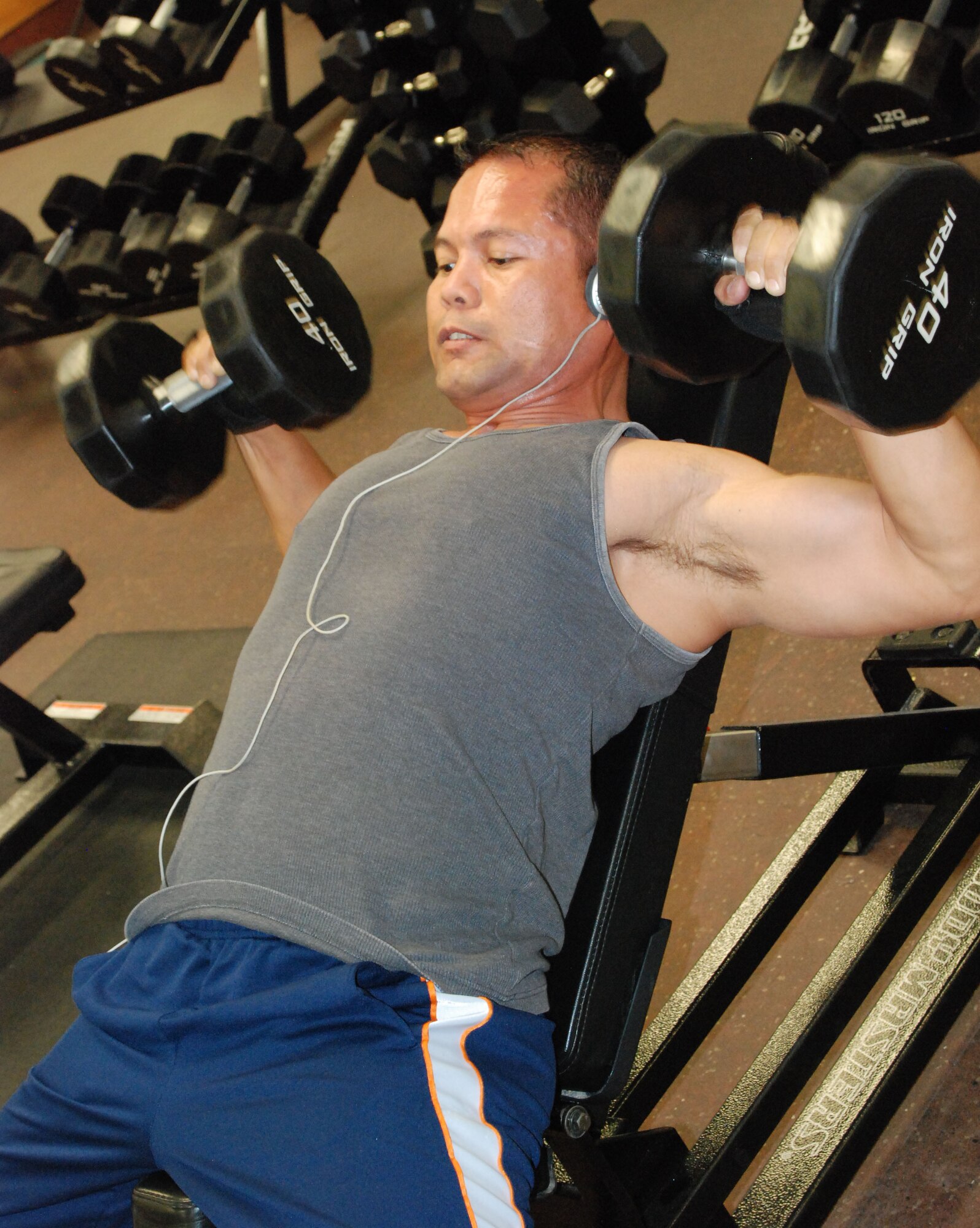 Herman Roberto, a 9th Support Division HAZMAT handler, lifts weights June 3 at the Harris Fitness Center. Mr. Roberto sticks to a strict workout routine and believes natural weightlifting is the best option. (Photo by Airman 1st Class Chuck Broadway)