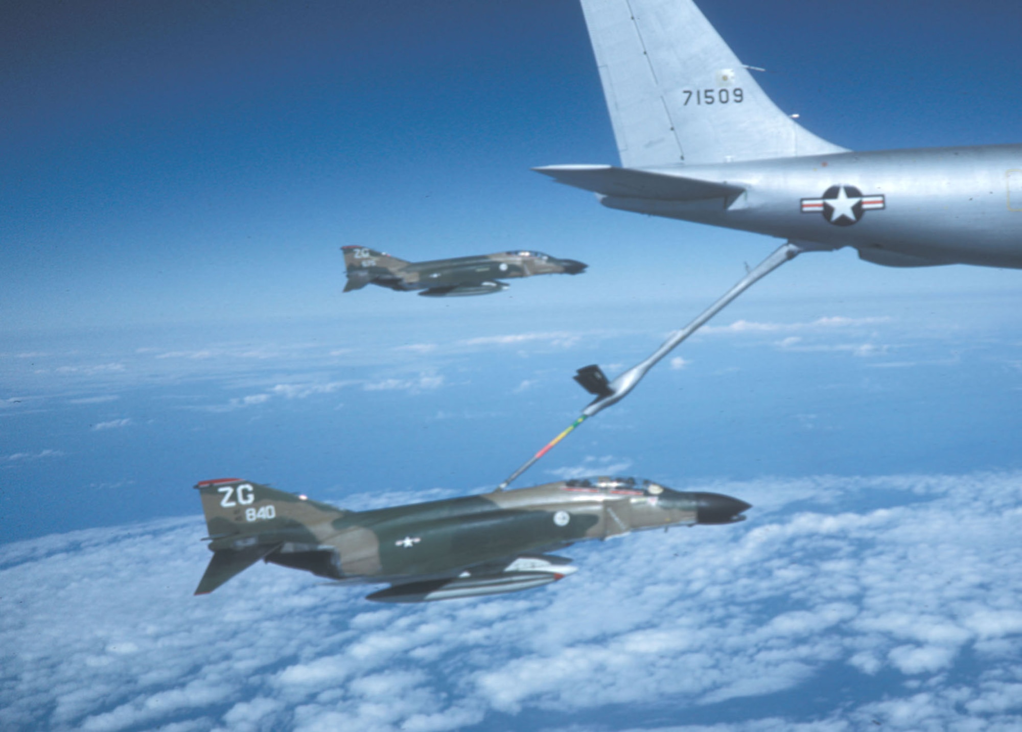 Two F-4C Wild Weasel aircraft flying back to Kadena Air Base, Okinawa, after the war's end. The F-4C in the back, tail number 675, is being flown by Capt. Myers. (U.S. Air Force photo)