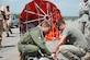 U.S. Army Sgts. Sidney Scott (left) and Michael Marquis, Joint Task Force-Bravo, work to attach a Bambi Bucket to a CH-47 Chinook helicopter to fight a forest fire near Tela, Honduras, June 3.  In all, the flight crew made 35 runs -- dropping more than 60,000 gallons of water on the blaze in a national wildlife reserve.  (U.S. Air Force photo/Tech. Sgt. Rebecca Danét)