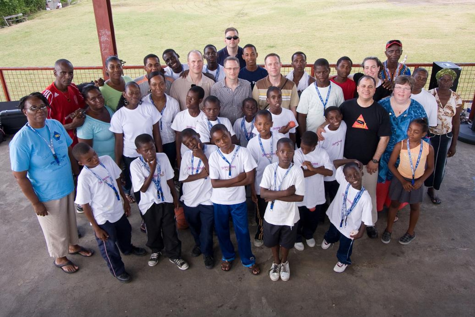 VICTORIA, Grenada -- Caretakers, children, volunteers and Airmen from the U.S. Air Force Academy Band “Blue Steel” pose for a group photograph in Victoria, Grenada, June 1.  Blue Steel spent the day with orphans from Father Mallaghan’s Home for Boys before performing a public concert in the center of the village.  The community outreach event is part of Operation Southern Partner, an Air Forces Southern-led event aimed at strengthening partnerships with nations in the U.S. Southern Command area of focus through mil-to-mil subject matter exchanges.  In addition to the exchange program, Airmen also had the opportunity to volunteer at various charitable and community organizations in each host nation.(Photo courtesy of Sagar Pathak of HorizontalRain.com) 