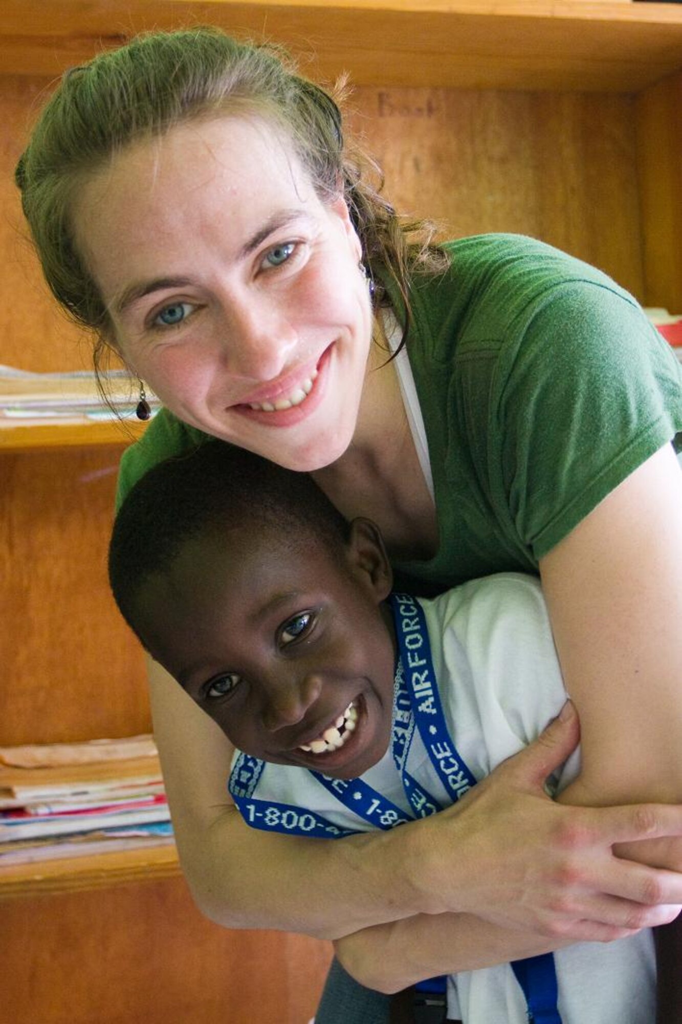 VICTORIA, Grenada -- Tech Sgt. Victoria Bruyette embraces a young boy at Father Mallaghan’s Home for Boys during a community outreach event June 1 at the home for orphaned and abused children.  Blue Steel spent the day with boys at the home before performing a public concert in the center of the village.  The community outreach event is part of Operation Southern Partner, an Air Forces Southern-led event aimed at strengthening partnerships with nations in the U.S. Southern Command area of focus through mil-to-mil subject matter exchanges.  In addition to the exchange program, Airmen also had the opportunity to volunteer at various charitable and community organizations in each host nation.  (Photo courtesy of Sagar Pathak of HorizontalRain.com)