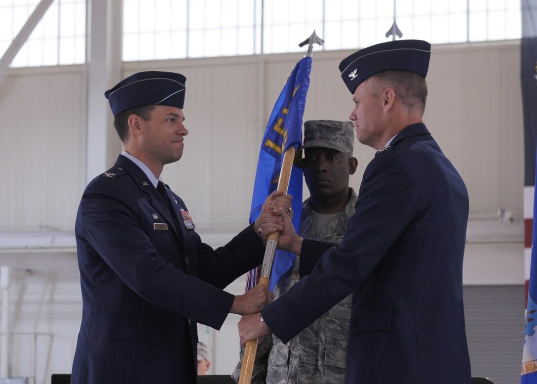 LANGLEY AIR FORCE BASE, Va. -- Col. George A. Zaniewski assumes command of the 1st Maintenance Group by accepting the guidon from Col. Matthew H. Molloy, 1st Fighter Wing commander, during the change of command ceremony here June 5. Colonel Zaniewski assumed command from Col. Tyrone A. Strachan.  (U.S. Air Force photo/Airman 1st Class Jonathan Koob)