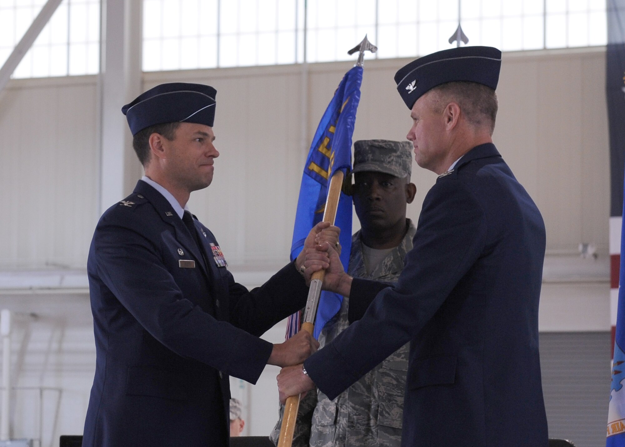 LANGLEY AIR FORCE BASE, Va. -- Col. George A. Zaniewski assumes command of the 1st Maintenance Group by accepting the guidon from Col. Matthew H. Molloy, 1st Fighter Wing commander, during the change of command ceremony here June 5. Colonel Zaniewski assumed command from Col. Tyrone A. Strachan.  (U.S. Air Force photo/Airman 1st Class Jonathan Koob)