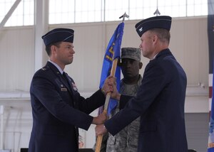 LANGLEY AIR FORCE BASE, Va. -- Col. George A. Zaniewski assumes command of the 1st Maintenance Group by accepting the guidon from Col. Matthew H. Molloy, 1st Fighter Wing commander, during the change of command ceremony here June 5. Colonel Zaniewski assumed command from Col. Tyrone A. Strachan.  (U.S. Air Force photo/Airman 1st Class Jonathan Koob)