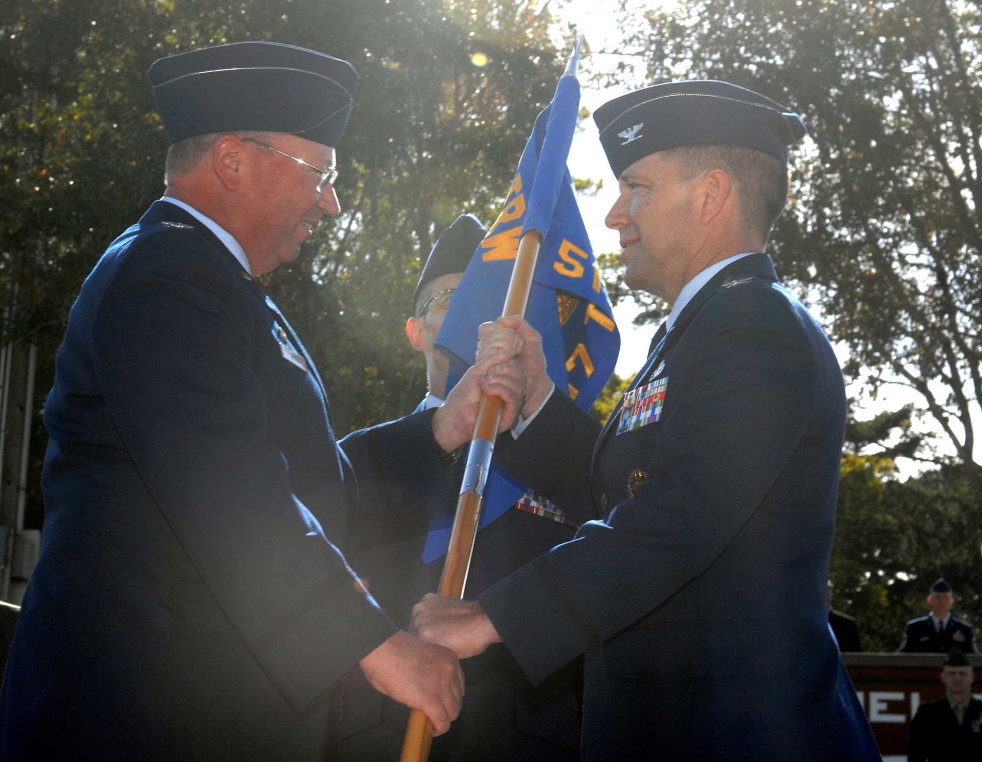 Colonel William "Terry" Bare (right), 517th Training Group commander, accepts the guidon for the 517th Training Group from Col. Richard Ayres, 17th Training Wing commander, at the stand-up of the 517 TRG at the Presidio of Monterey, Calif., May 15. The 517 TRG will encompass the 311th and 314th Training Squadrons and replaces the Air Force Element. (U.S. Air Force photo by Tech. Sgt. John Barton)