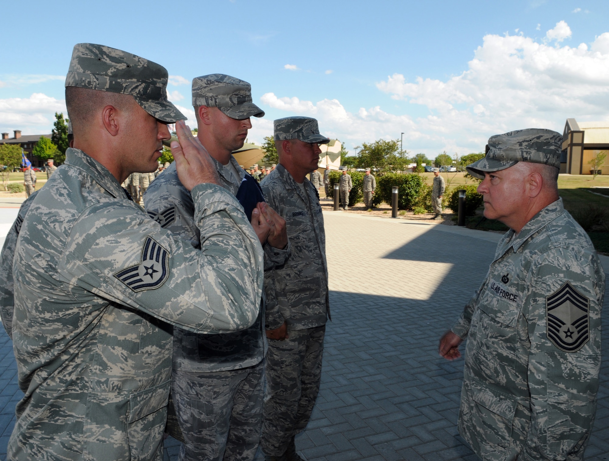 Chief Master Sgt. David Crane, 17th Training Group superintendent, Staff Sgt. Richard Lingle, 312th Training Squadron, Staff Sgt. Richard Wentzel, 17th Training Group, and Staff Sgt. Randal Brooks, 316th Training Squadron, participate in a retreat ceremony in honor of the late first Chief Master Sgt. of the Air Force Paul Airey May 28. (U.S. Air Force photo by Tech. Sgt. John Barton)