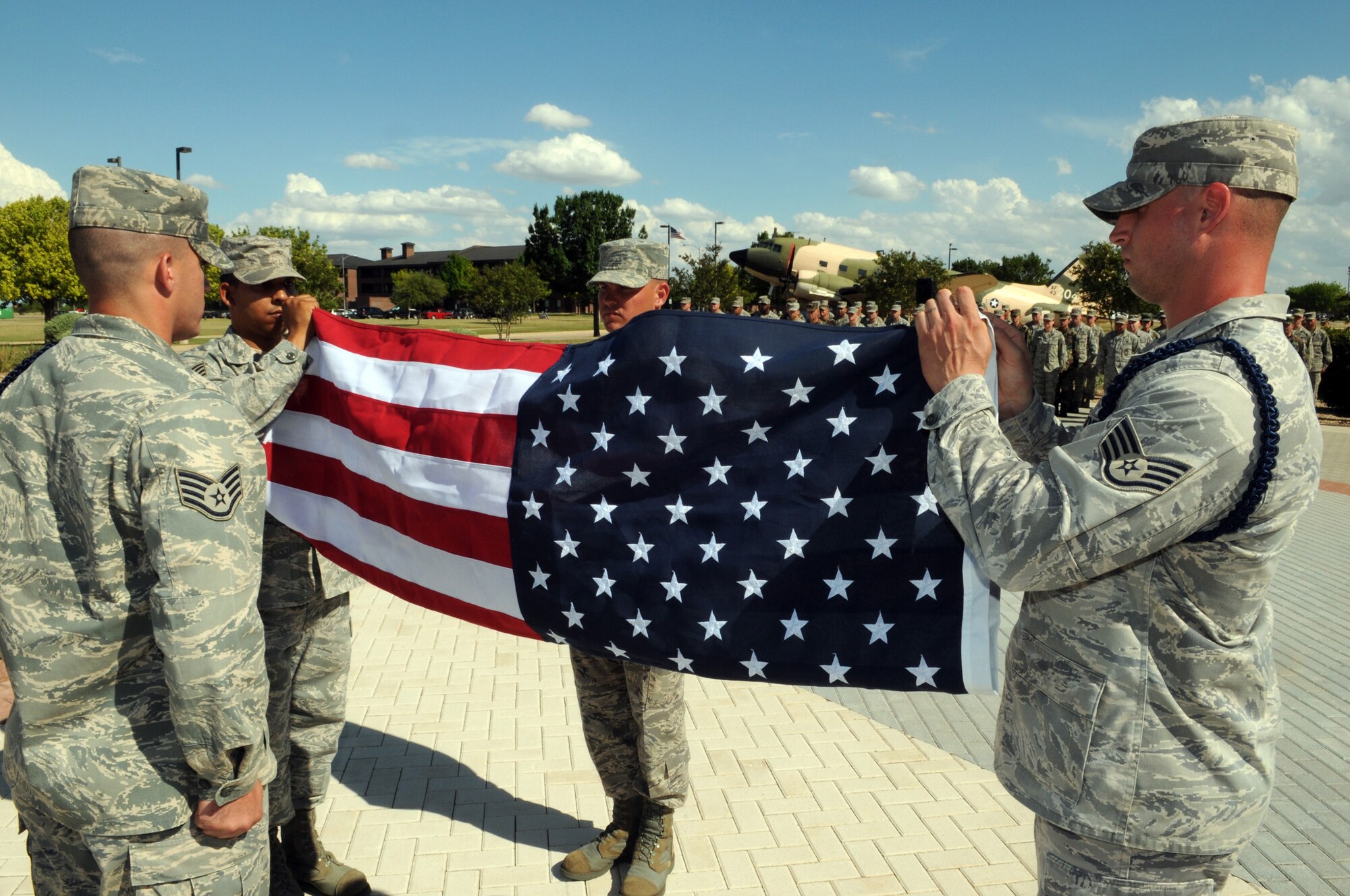 Military Training Leaders from the 17th Training Group, fold the flag during a retreat ceremony in honor of the late first Chief Master Sgt. of the Air Force Paul Airey May 28. (U.S. Air Force photo by Tech. Sgt. John Barton)