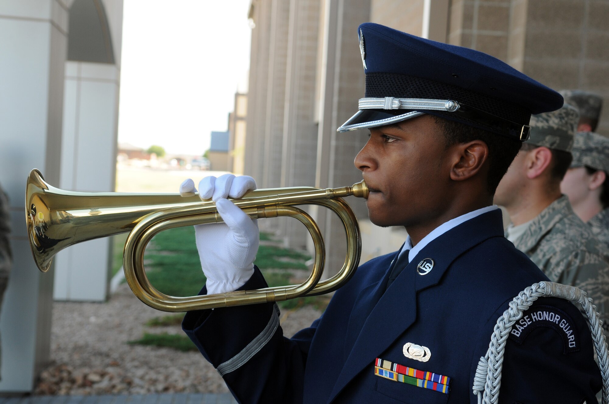 Senior Airman Everrett Campbell, 17th Communications Squadron, a member of the base honor guard, plays taps, May 28 at the ceremony honoring the late Chief Master Sgt. of the Air Force Paul Airey. (U.S. Air Force photo by Tech. Sgt. John Barton)