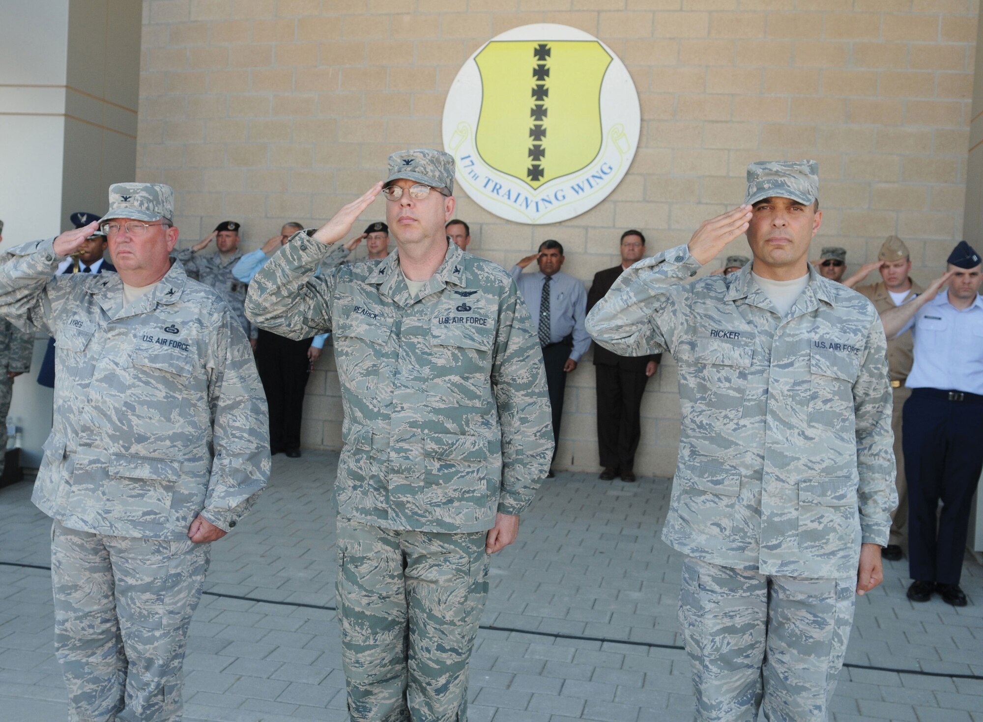 Colonel Richard Ayres, 17th Training Wing commander, Colonel David Rearick, 17th Training Wing vice commander and Chief Master Sgt. Frederick Ricker, 17th Training Wing command chief master sergeant salute during the special retreat ceremony, May 28, held in honor of the late first Chief Master Sergeant of the Air Force Paul Wesley Airey. (U.S. Air Force photo by Tech. Sgt. John Barton)