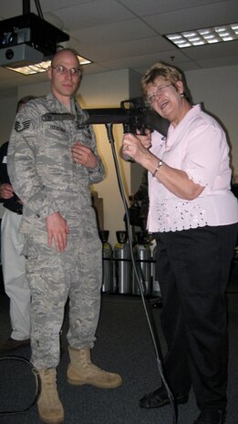 Staff Sgt. Stephen Houseman, 914th Security Forces Squadron, Niagara Falls, NY, instructs Linda Taylor, the president of Dearybury Oil & Gas, on the M-16 at the fire arms training simulator.  Ms. Taylor participated on the Employer Support of the Guard and Reserve Bosslift trip taken to Niagara Falls to see a military mission first-hand.  (U.S. Air Force photo / Debra Baldwin)