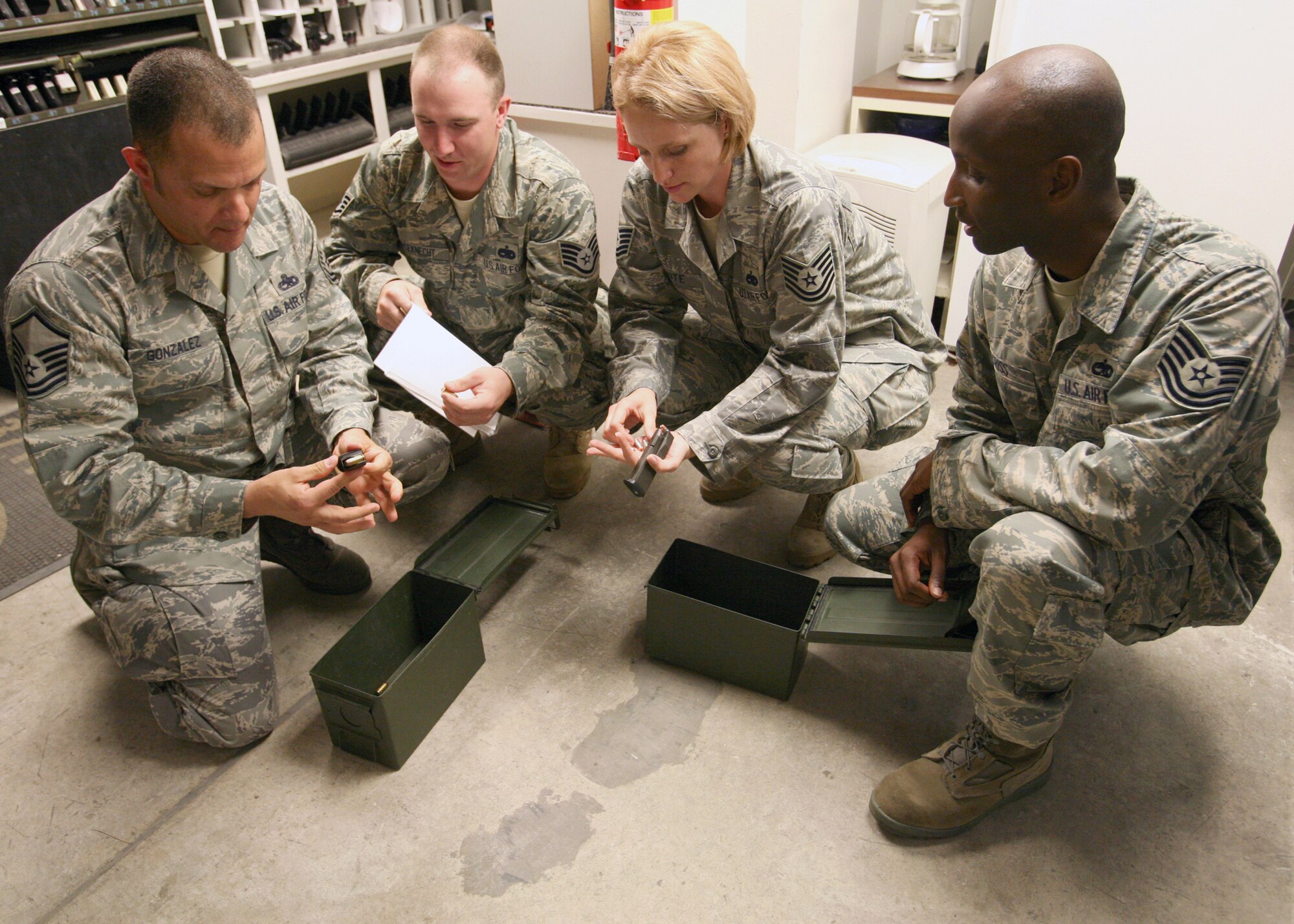 From left to right, Safety Academy students Master Sgt. Adolfo Gonzalez, Staff Sgt. Vincent Houseknecht, and Tech. Sgt. Joanna Clute ensure security forces have the approved amount of bullets during field training at the security forces armory while Tech. Sgt. Tyrone Criss, Safety Academy superintendent, observes. (U.S. Air Force photo/Robbin Cresswell) 

