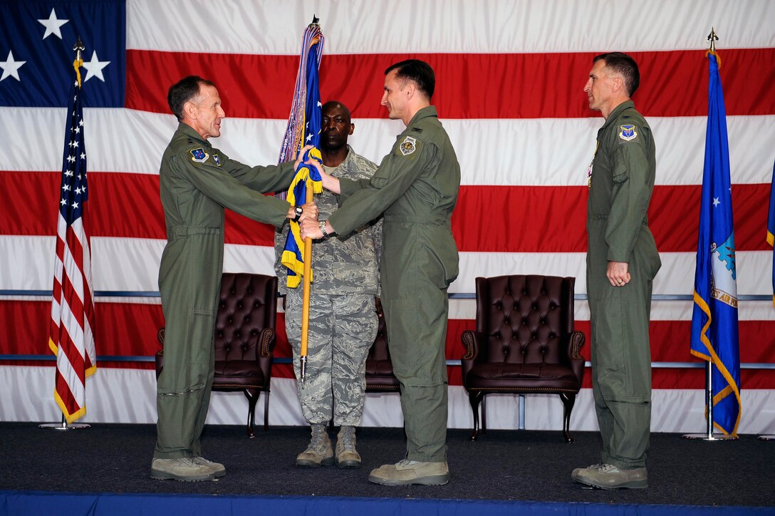 Col. Jeffrey Taliaferro, incoming 28th Bomb Wing commander, receives the guidon from  Lt. Gen. Norman Seip, 12th Air Force commander, during the change of command ceremony here, June 4. The receiving of the guidon symbolizes Col. Jeffrey Taliaferro assuming command from the outgoing 28 BW commander Col. Scott Vander Hamm. (U.S. Air Force photo by Airman 1st Class Corey Hook)