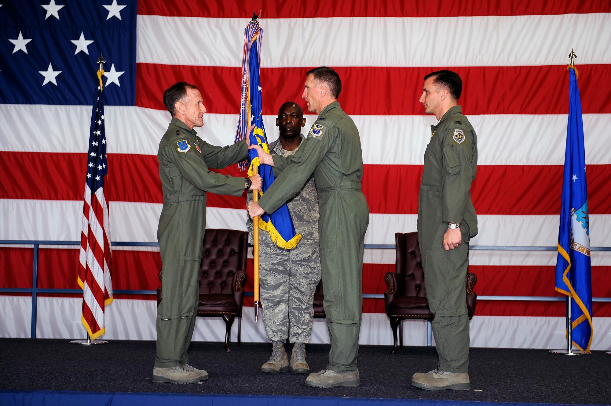 Col. Scott Vander Hamm, outgoing 28th Bomb Wing commander, hands the guidon to Lt. Gen. Norman Seip, 12th Air Force commander, during the change of command ceremony here, June 4. The handing off of the guidon symbolizes Col. Vander Hamm relinquishing command to the incoming 28 BW commander Col. Jeffrey Taliaferro. (U.S. Air Force photo by Airman 1st Class Corey Hook)