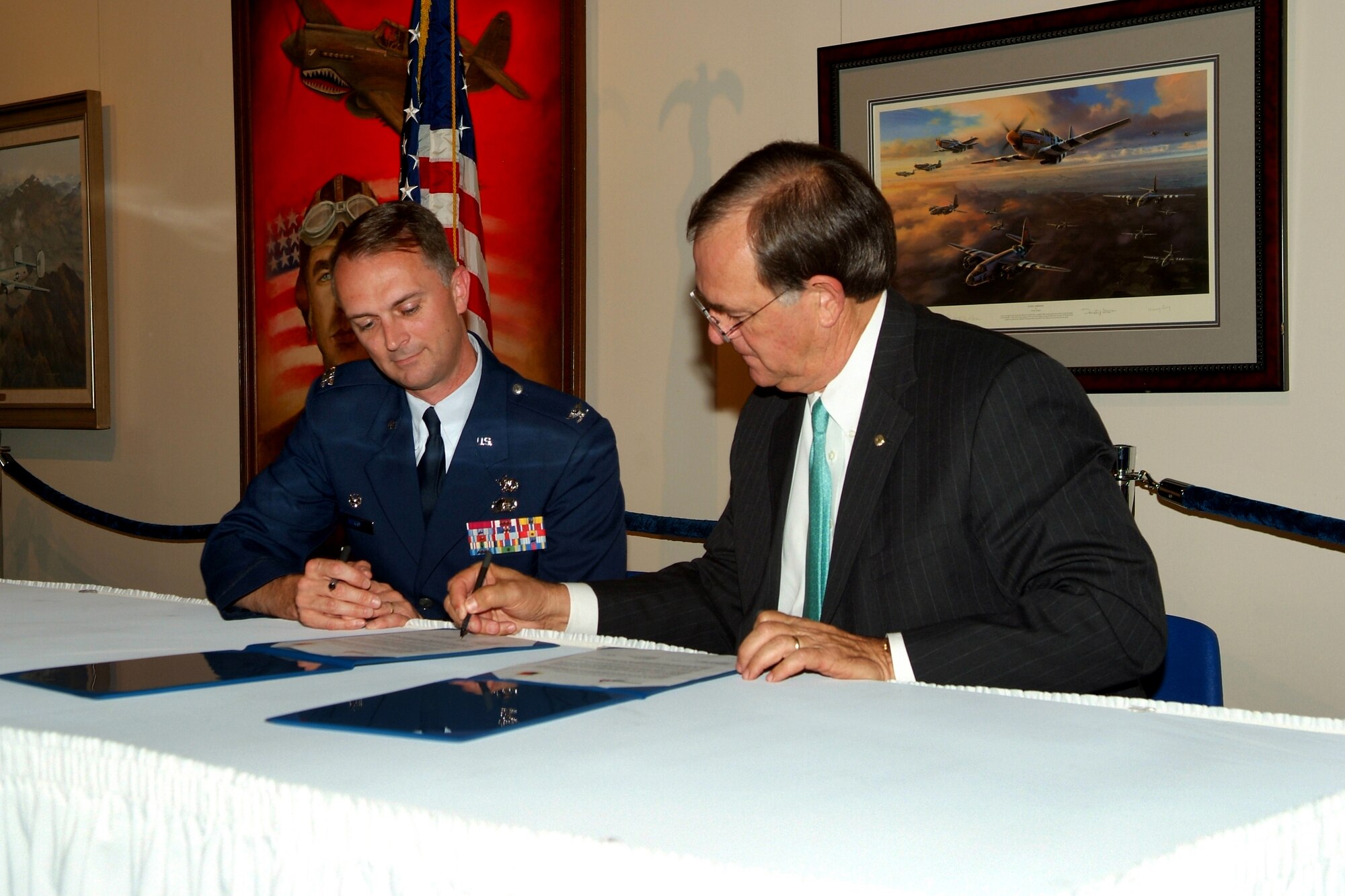 Col. Warren Berry, 78th Air Base Wing commander and Michael Garrett, Georgia Power CEO sign an agreement to form a team to explore energy options at Robins. U. S. Air Force photo by Gary Cutrell