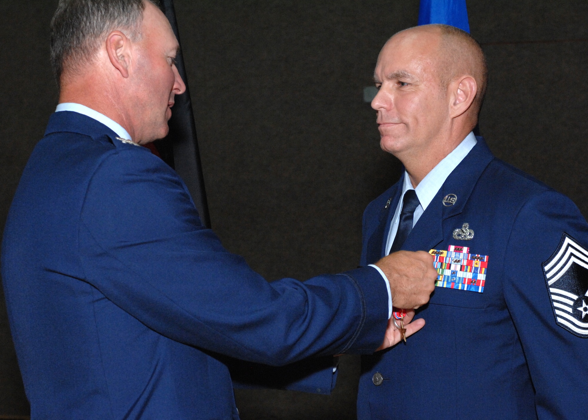 SPANGDAHLEM AIR BASE, GERMANY – Col. Lee T. Wight 52nd Fighter Wing commander, presents a Bronze Star to Chief Master Sgt. William J. Brown, 52nd Component Maintenance Squadron propulsion systems manager, during the 52nd Maintenance Group Unit Compliance Inspection call June 1, 2009 at the base fitness center. Chief Brown was awarded the medal for achievement as superintendent of the 451st Air Expeditionary Group at Kandahar Airfield, Afghanistan, from Dec. 31, 2007 to May 7, 2008. While exposed to repeated Taliban rocket attacks, Chief Brown led more than 500 Airmen in support of Operation Enduring Freedom. He fostered vital rapport with command sergeants major from numerous units to resolve issues and enforce standards for more than 13,000 Joint and Coalition forces. (U.S. Air Force photo by Master Sgt. Bill Gomez) 