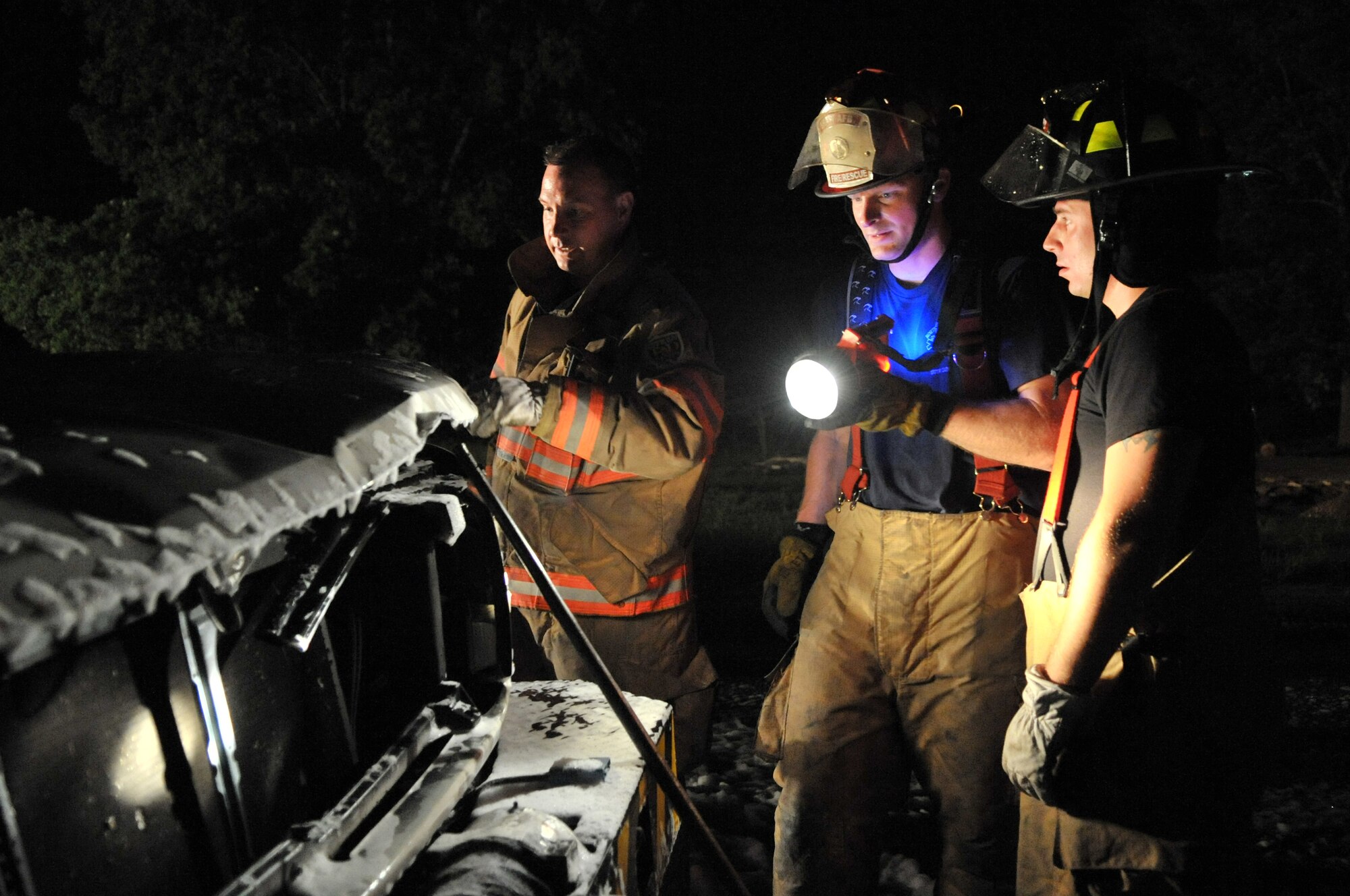 SHAW AIR FORCE BASE, S.C. -- Captain Gregory Farley, left, Staff Sgt. Marcus Hewett, center, and Staff Sgt. Corey Ford, all members of the 20th Civil Engineer Squadron, examine the remains of a government vehicle, May 30. The vehicle caught fire at 3:45 a.m. from an electrical short. (U.S. Air Force photo/Senior Airman Kathrine McDowell)