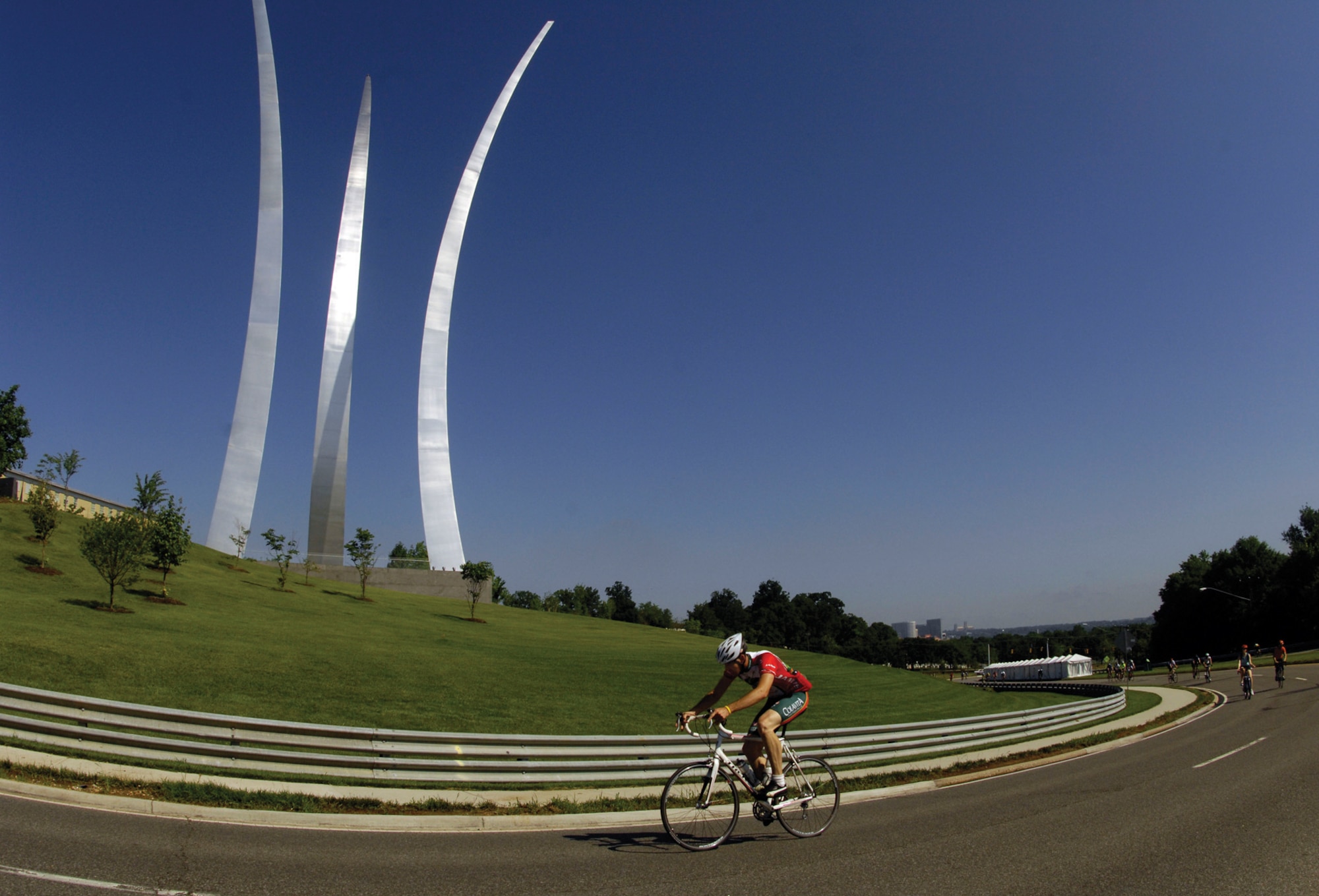 Staff Sgt. Jake Esinger, 316th Security Forces Squadron unit security manger, cycles past the U.S. Air Force Memorial in Arlington, Va. during the Air Force Cycling Classic Men’s Pro race May 29. Over 1,000 racers participated in the 100 km race. Sergeant Esinger recieved a medal for placing 114th, with a time of 3 hours and 16 minutes. (U.S. Air Force photo/ Senior Airman Steven R. Doty)
