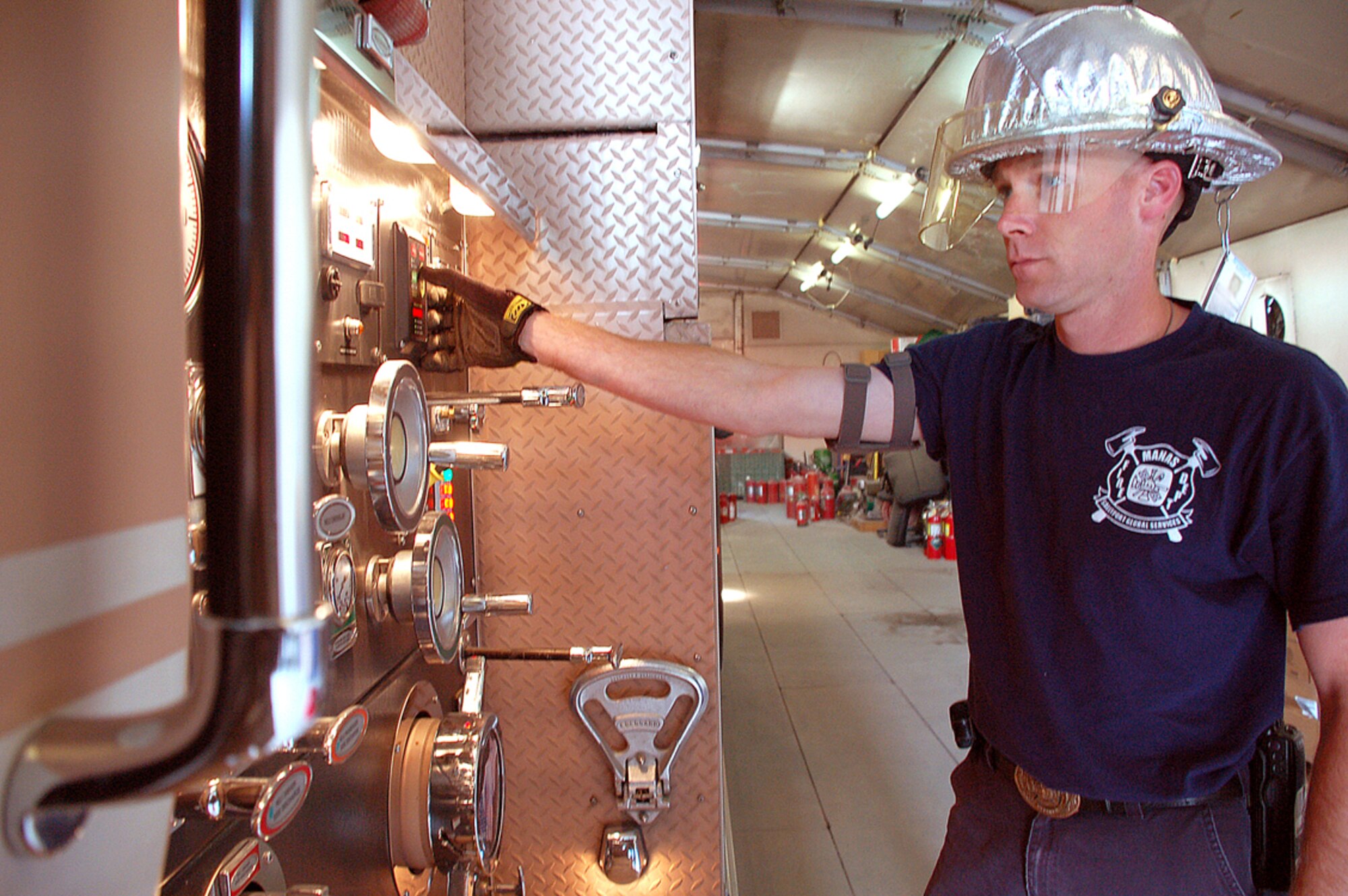Dustin Miller does an early morning check of the fire truck?s control panel to ensure everything is in working order to be ready at a moment?s notice at Manas Air Base, Kyrgyzstan. Mr. Miller has been a firefighter for 13 years, having served in the Air Force and Army. He recently served at Manas for one year as a Sallyport Global Services contractor with the 376th Expeditionary Civil Engineer Squadron here. The Manas fire department stands ready 24/7 to protect the flightline, living quarters and support facilities at Manas. (U.S. Air Force photo/Tech. Sgt. Phyllis Hanson)