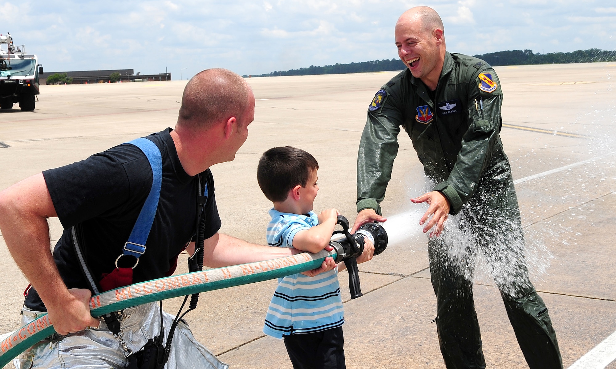 Staff Sergeant Jonathan Jeffers, 4th Civil Engineer Squadron, helps Jack DeBree spray down Colonel Daniel DeBree, 4th Fighter Wing vice commander, after his final flight at Seymour Johnson Air Force Base, N.C., June 4, 2009. Col. DeBree is moving on to serve as the commander of the University of Virginia's Reserve Officer Training Corps. (U.S. Air Force photo by Airman 1st Class Rae Perry)