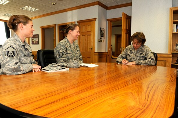 Col. Eden J. Murrie, 100th Air Refueling Wing commander, signs a form to become an associate member of the Air Force Sergeants Association while Master Sgt. Jessica Hensley and Tech Sgt. Rebecca Janssen, chapter 1670 council members, look on, June 4, at RAF Mildenhall.  (U.S. Air Force photo by Staff Sgt. Christopher L. Ingersoll)