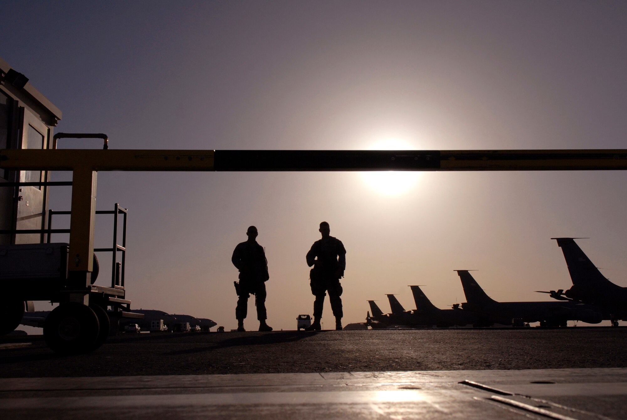 Airman 1st Class Christopher Salazar, a 379th Expeditionary Security Forces Squadron (ESFS) entry controller, and Senior Airman Chad Byall, also a 379th ESFS entry controller, stand their post at an entry control point on the flightline, Jun 4, 2009, at an undisclosed location in Southwest Asia.  Both Airmen ensure that personnel who are attempting to gain access to the flightline have authorization to do so.  Airman Salazar hails from Colorado Springs, Colo. and is deployed from Royal Air Force Mildenhall, England.  Airman Byall hails from Hattiesburg, Miss. and is deployed from Keesler Air Force Base, Miss.  Both are deployed in support of Operations Iraqi and Enduring Freedom and Combined Joint Task Force - Horn of Africa.  (U.S. Air Force photo/Senior Airman Andrew Satran/released)