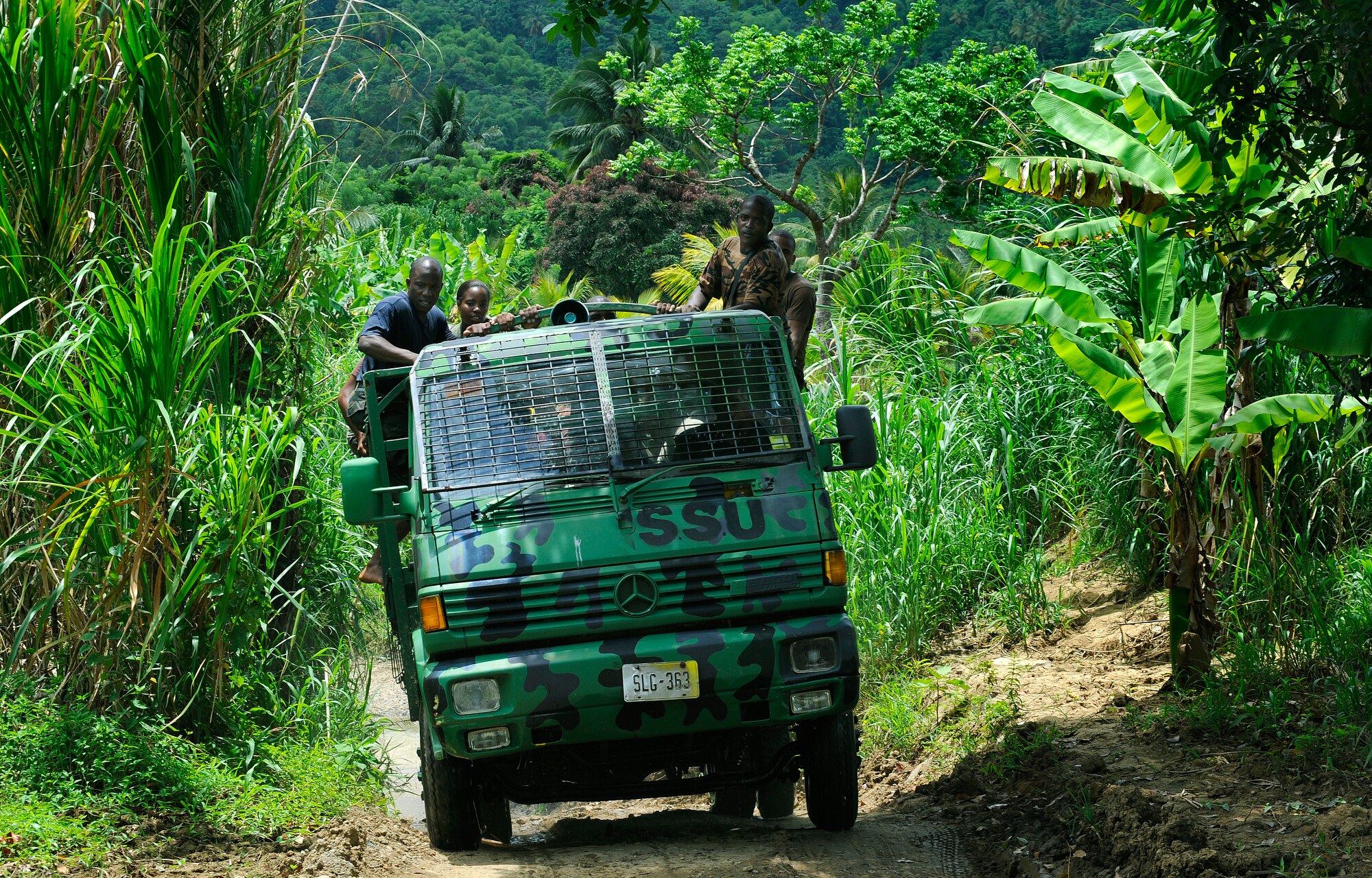 Members of the Royal St. Lucia Police Force's Special Service Unit make their way through the jungle terrain June 5 in search of a location to practice swift-water rescue procedures that were being taught by U.S. Air Force pararescuemen during Operation Southern Partner at La Toc, St. Lucia. Operation Southern Partner is a long term commitment between U.S. and partner nations to share experiences, information, vital skills, tactics and techniques in preparation for future regional challenges that require cooperative solutions.  (U.S. Air Force photo/Staff Sgt. Bennie J. Davis III)