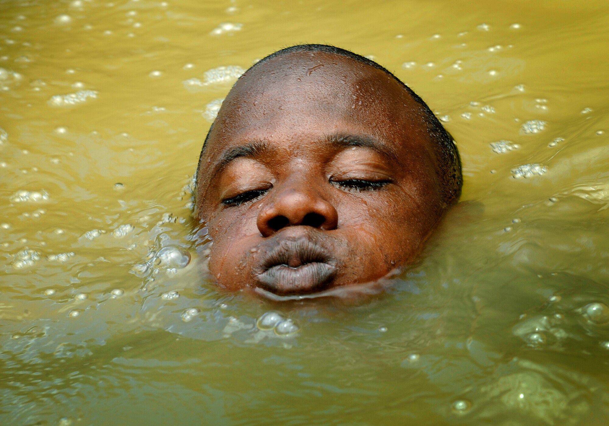 Constable allen Abbott of the Royal St. Lucia Police Force's Special Service Unit tries to stay afloat while practicing swiftwater rescue procedures during Operation Southern Partner, La Toc, St. Lucia, June 5. Operation Southern Partner is a long term commitment between U.S. and  partner nations to share experiences, information, vital skills, tactics and techniques in preparation for future regional challenges that require cooperative solutions.  
(U.S. Air Force photo by/Staff Sgt. Bennie J. Davis III) 