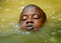 Constable allen Abbott of the Royal St. Lucia Police Force's Special Service Unit tries to stay afloat while practicing swiftwater rescue procedures during Operation Southern Partner, La Toc, St. Lucia, June 5. Operation Southern Partner is a long term commitment between U.S. and  partner nations to share experiences, information, vital skills, tactics and techniques in preparation for future regional challenges that require cooperative solutions.  (U.S. Air Force photo by/Staff Sgt. Bennie J. Davis III) 