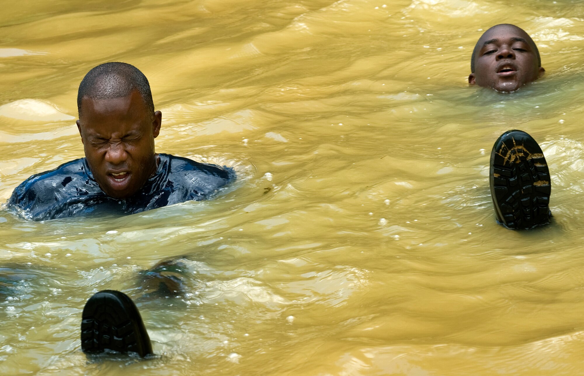 Members of the Royal St. Lucia Police Force's Special Service Unit try to stay afloat while practicing swift-water rescue procedures that were taught by U.S. Air Force pararescuemen June 5 during Operation Southern Partner at La Toc, St. Lucia. Operation Southern Partner is a long term commitment between U.S. and partner nations to share experiences, information, vital skills, tactics and techniques in preparation for future regional challenges that require cooperative solutions.  (U.S. Air Force photo/Staff Sgt. Bennie J. Davis III)