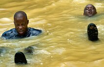 Members of the Royal St. Lucia Police Force's Special Service Unit try to stay afloat while practicing swift-water rescue procedures that were taught by U.S. Air Force pararescuemen June 5 during Operation Southern Partner at La Toc, St. Lucia. Operation Southern Partner is a long term commitment between U.S. and partner nations to share experiences, information, vital skills, tactics and techniques in preparation for future regional challenges that require cooperative solutions.  (U.S. Air Force photo/Staff Sgt. Bennie J. Davis III)