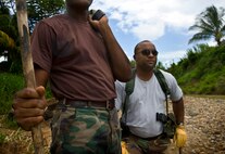 Constables Jameson Jeremy and Alphonse Cyril, members of the Royal St. Lucia Police Force's Special Service Unit, listen to instructions before practicing swift-water rescue procedures that were being taught by U.S. Air Force pararescuemen June 5 during Operation Southern Partner at La Toc, St. Lucia. Operation Southern Partner is a long term commitment between U.S. and partner nations to share experiences, information, vital skills, tactics and techniques in preparation for future regional challenges that require cooperative solutions.  (U.S. Air Force photo/Staff Sgt. Bennie J. Davis III)