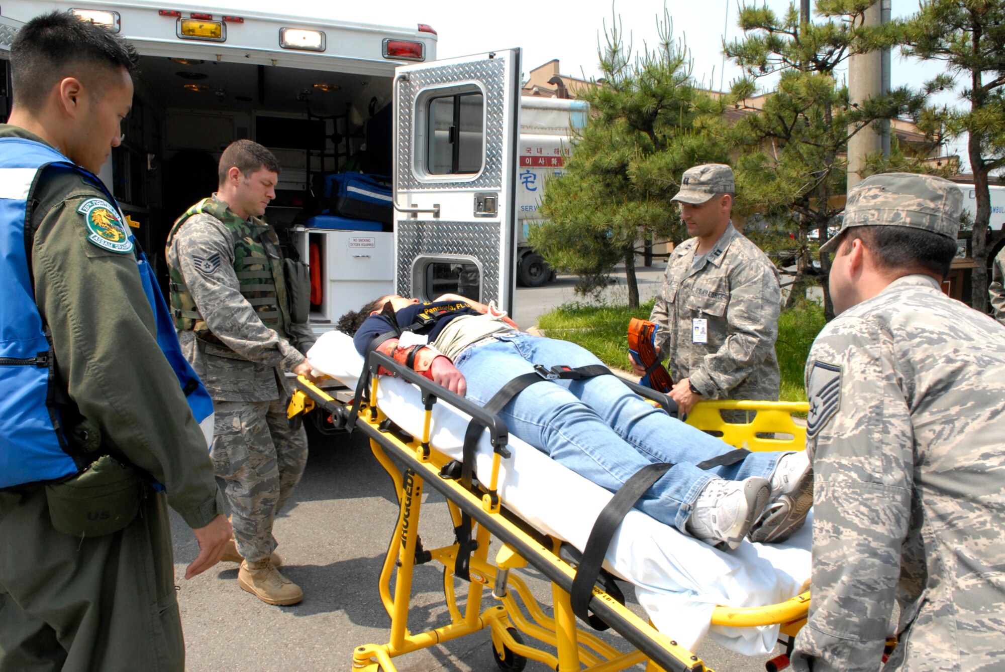 Airmen from the 51st Medical Group load a simulated injured Airman into an ambulance after a simulated an exercise suspicious package explosion May 28 at Osan AB, Republic of Korea. EME’s are held quarterly to test Osan’s preparedness for force protection issues and acts of terrorism. (U.S. Air Force photo/Senior Airman Stephenie Wade)