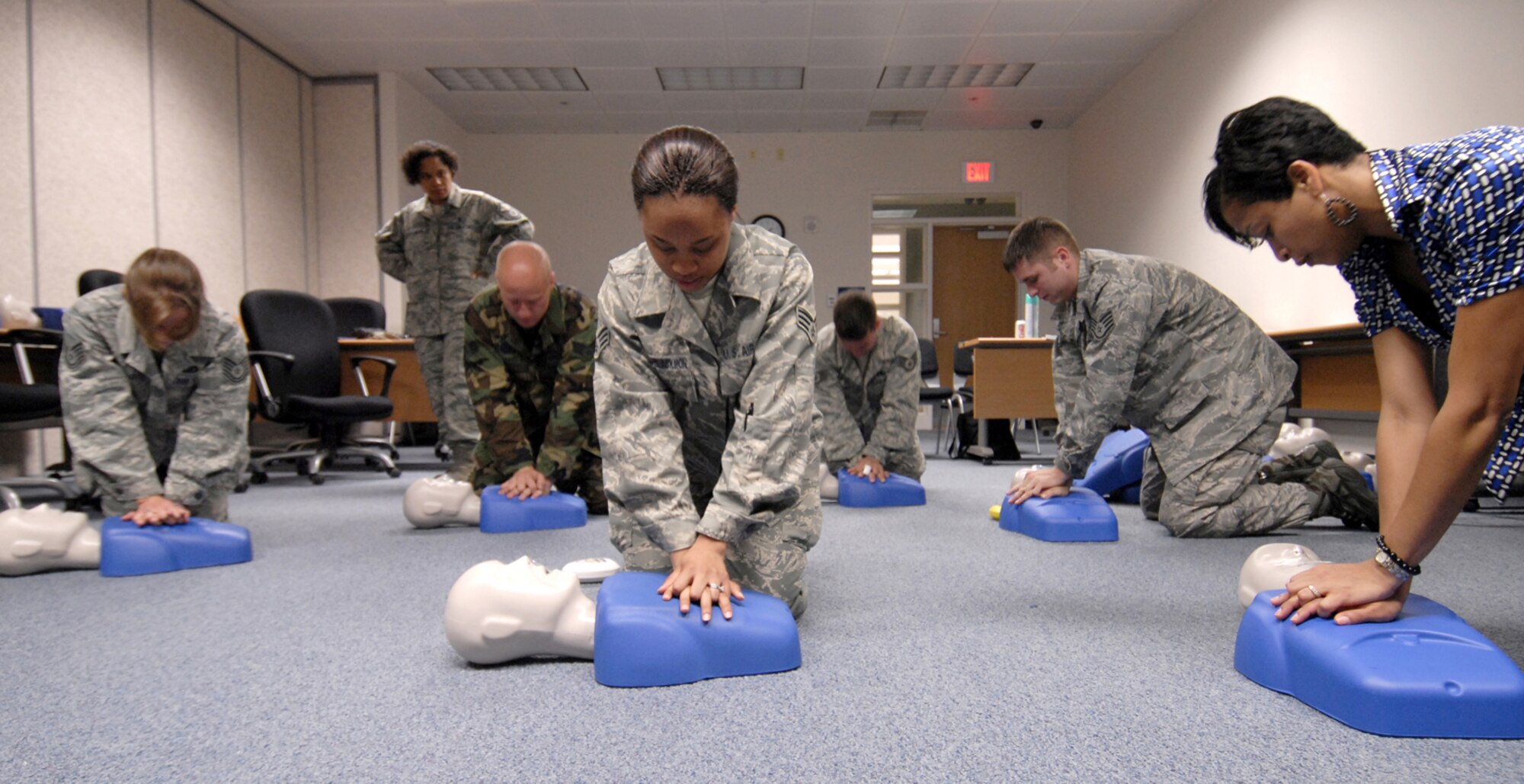 Members of Team Osan practice cardiopulonary resuscitation June 3 in the McPherson Community Activity Center here, as part of the National CPR and Automated External Defibrillator Awareness Week. The week is intended to bring attention to the problem of sudden cardiac arrest as well as the significance of CPR
skills and AED access and training. The American Heart Association and American
Red Cross’s goal for the wek was to have one million people CPR trained. Here at Osan, more than 250 people were trained. (U.S. Air Force photo/Senior Airman Stephenie Wade)